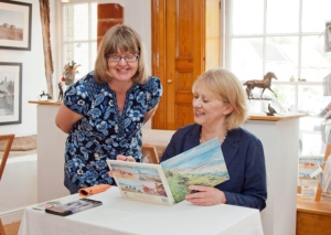 Mary Gundry signing her book Drawn to Southwold
