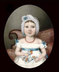 A young girl, in white dress with blue sash and bows at her shoulders, wearing coral beads and a lace cap; seated on a sofa